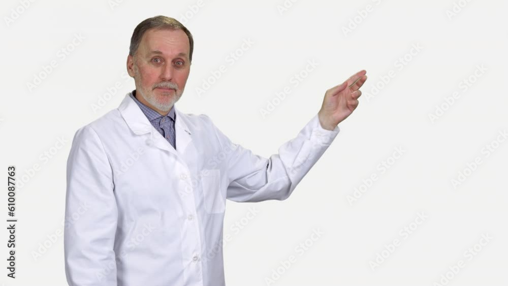 Portrait of thoughtful aged make doctor in white coat. Isolated on white.