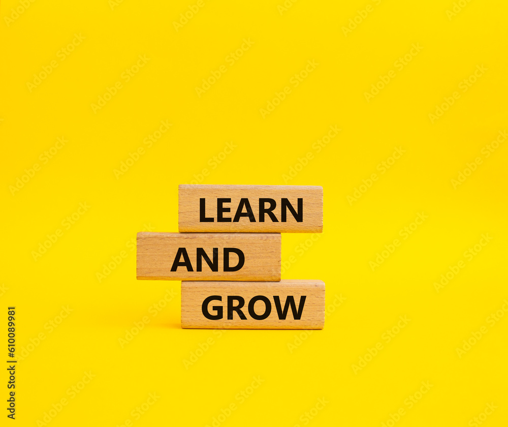 Learn and grow symbol. Concept words Learn and grow on wooden blocks. Beautiful yellow background. Business and Learn and grow concept. Copy space. Learn and grow symbol. Concept words Learn and grow on wooden blocks. Beautiful yellow background. Business and Learn and grow concept. Copy space.