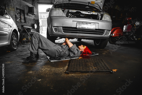 Auto car repair service center. Mechanic standing by the car. Auto mechanic working in garage. Repair service. young woman working in workshop. shot of handsome car mechanic repairing automobile 