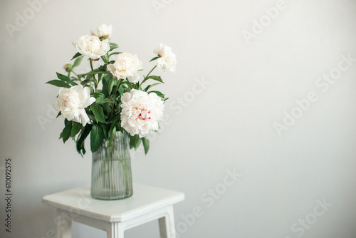 bouquet of white flowers peonies in a vase on the chair