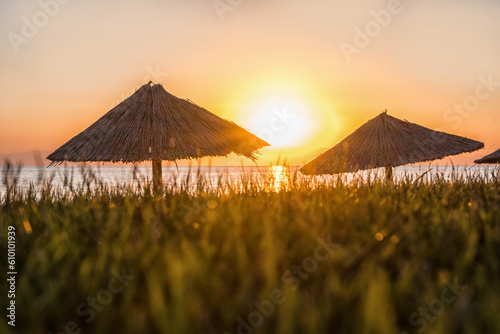 reed umbrella on the beach and beautiful sunset in Turkey