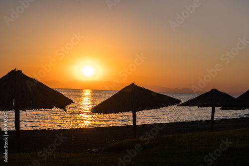 reed umbrella on the beach and beautiful sunset in Turkey