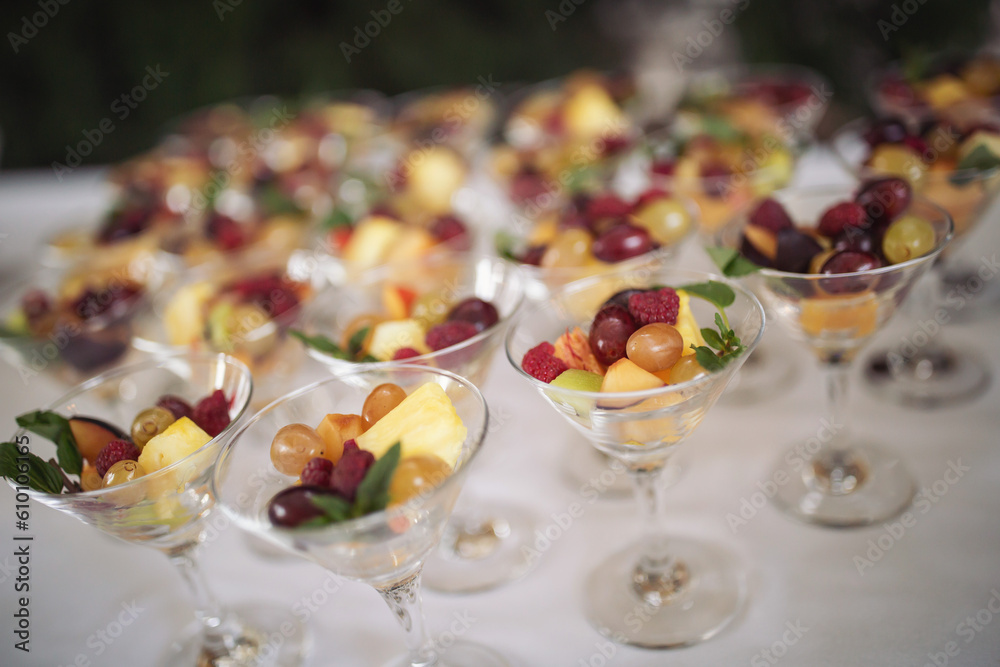 Catering on wedding. Sweet table with fruit, wedding catering. Fruit bar on party. Nicely decorated fresh berries dessert served for an event, catering service, celebration meal time.