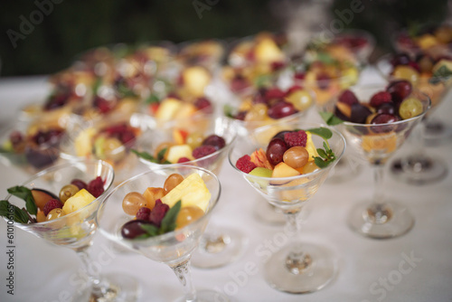 Catering on wedding. Sweet table with fruit, wedding catering. Fruit bar on party. Nicely decorated fresh berries dessert served for an event, catering service, celebration meal time.