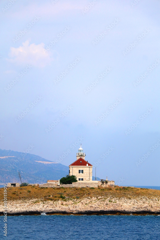 Picturesque stone lighthouse on a tiny island near Hvar, Croatia.