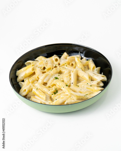 Homemade Italian four cheese pasta with parsley on white background