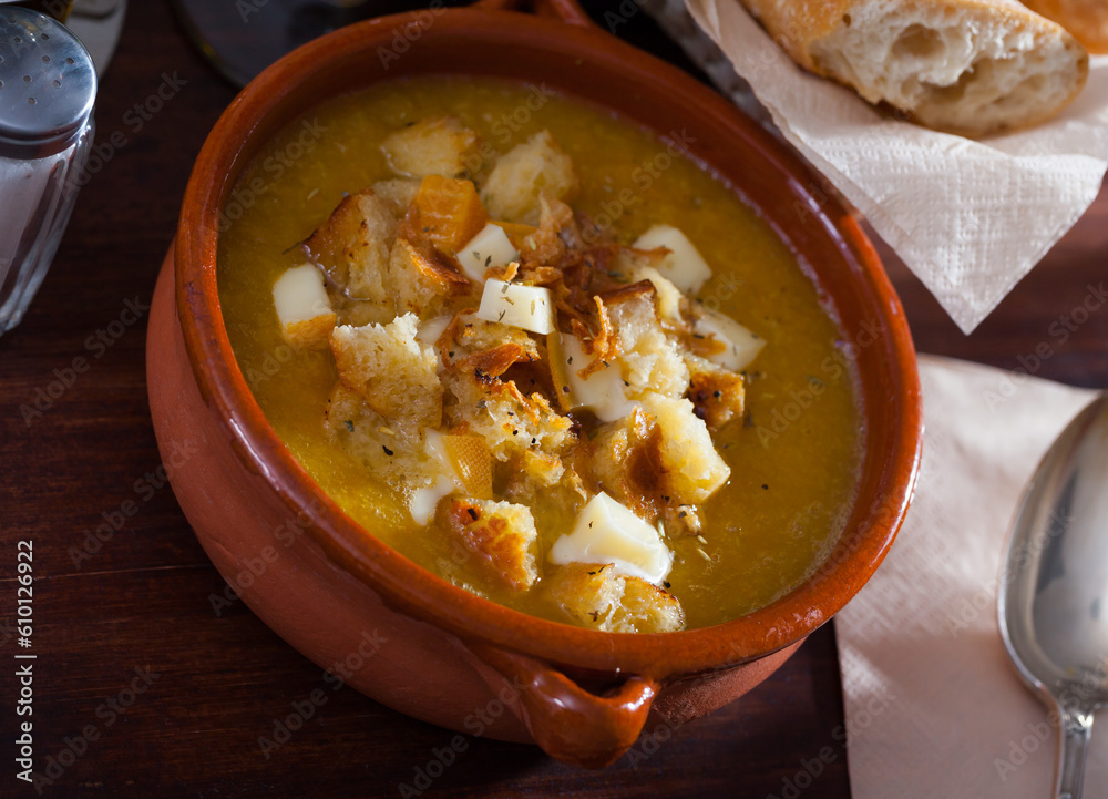 Vegetable soup with croutons and cheese in a clay plate. High quality photo