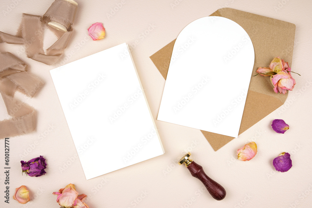 Fototapeta premium 5x7 arch card wedding stationery suite mockup. Styled with silk ribbon, vintage wax seal and dried roses on a beige background. Wedding program and arch invitation card.