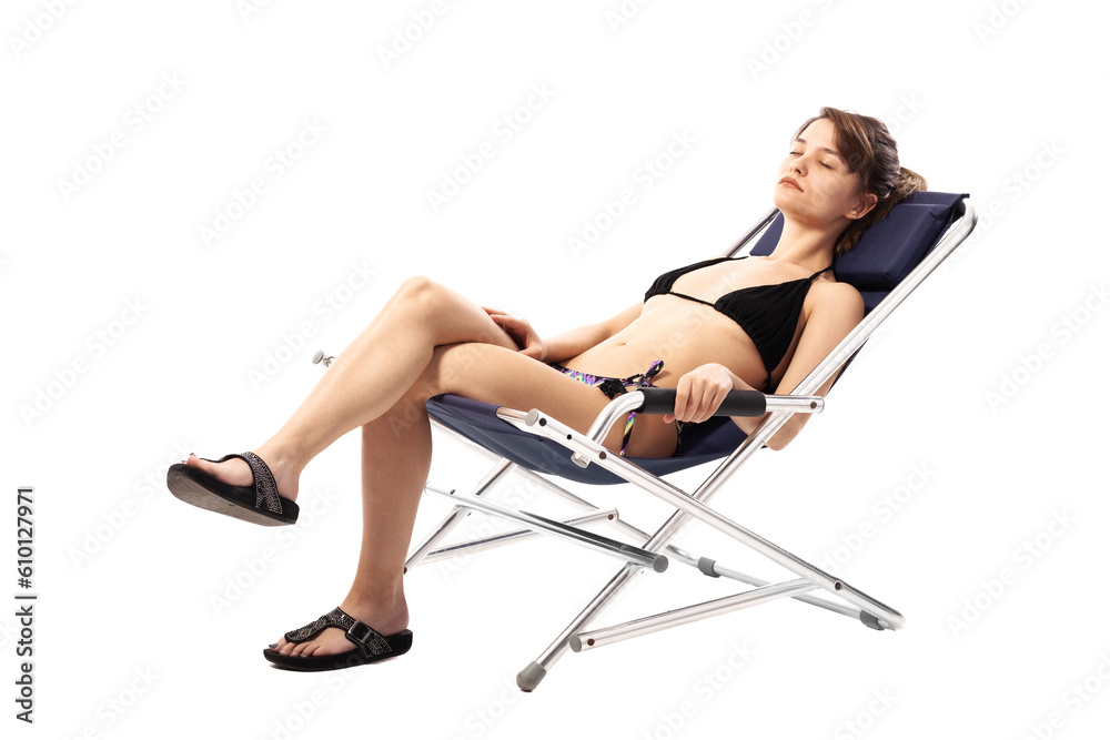 Beautiful young girl in swimsuit relaxing on beach deckchair isolated on white background. Summer concept.