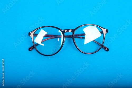 clear glasses isolated on blue background