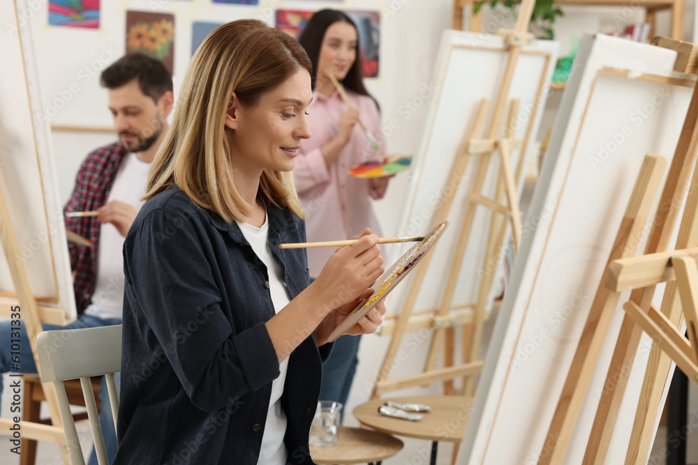 Group of students attending painting class in studio. Creative hobby Group of students attending painting class in studio. Creative hobby