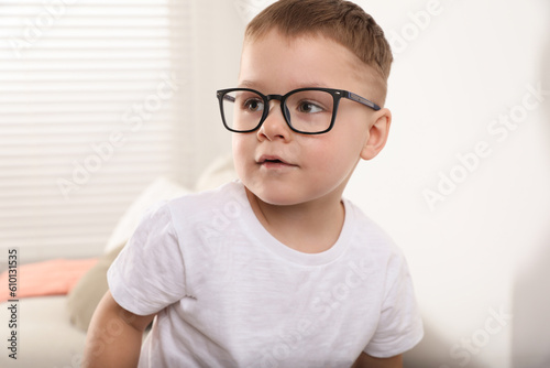 Cute little boy in glasses at home