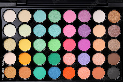 Beautiful eyeshadow palette as background, top view. Professional cosmetic product photo