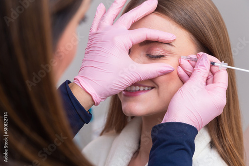 Woman wearing bathrobe in beauty clinic, aesthetics, patient, cosmetic procedures. botox application. anti wrinkle and anti aging. photo