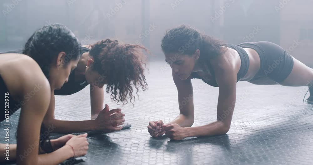 Plank, women and fitness of group exercise, sports class and muscle workout for training, challenge and gym floor. Focused female friends, push up and body balance on elbow for strong core on ground