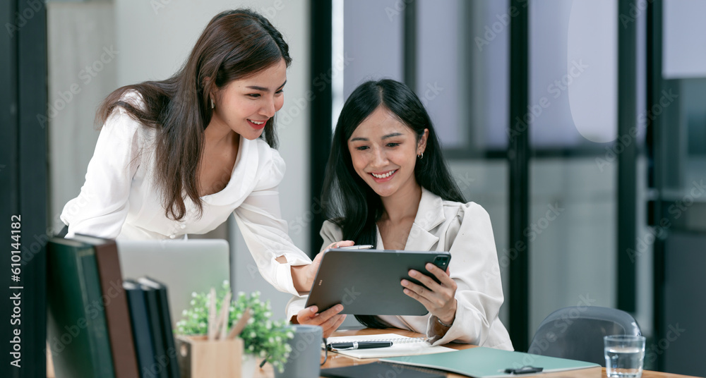 Two Young smiling businesswoman discuss with new startup project Idea presentation and investment market at office. Two Young smiling businesswoman discuss with new startup project Idea presentation and investment market at office.