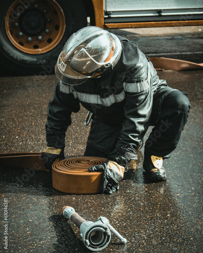 firefighter picking up equipment
