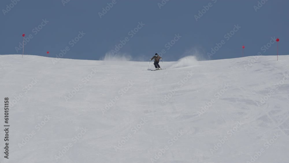 Skier Skiing Down Snowy Mountainside Skier Skiing Down Snowy Mountainside