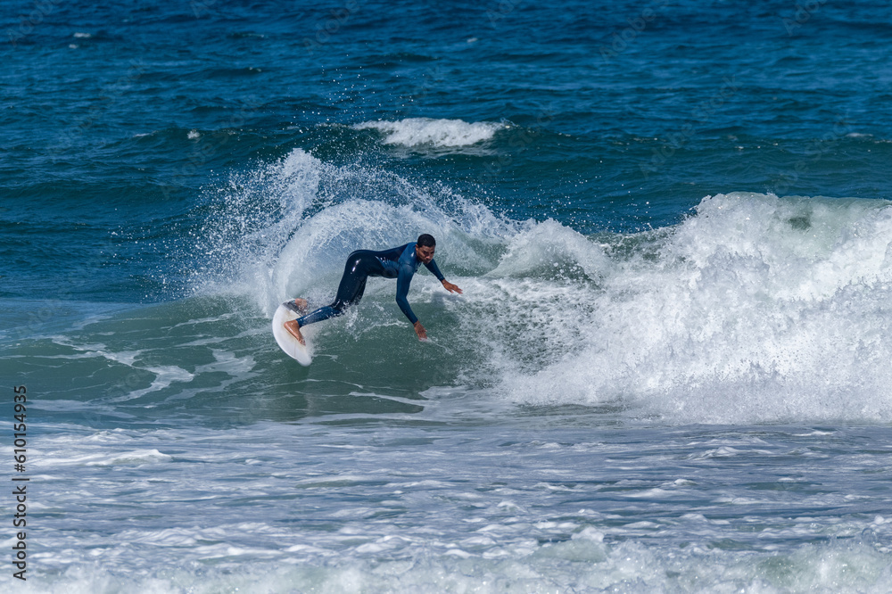 Surfer riding waves in Furadouro Beach