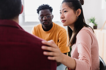 Meeting of young people in group therapy supporting each other at community center. Help and support concept.