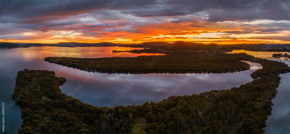 A moody winter sunrise panorama waterscape with clouds A moody winter sunrise panorama waterscape with clouds