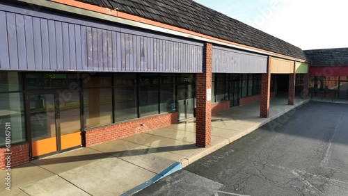 Empty, desolate, deserted shopping outlets theme. Close up aerial view of abandoned retail space in USA.
