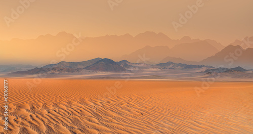 Panoramic view of orange sand dune desert with orange mountains and hill - Namib desert, Namibia