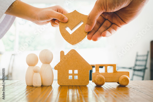 Businessman holding shield protect icon with his child, Security protection and health insurance. The concept of family home, protection, health care day, car insurance and home school education. photo