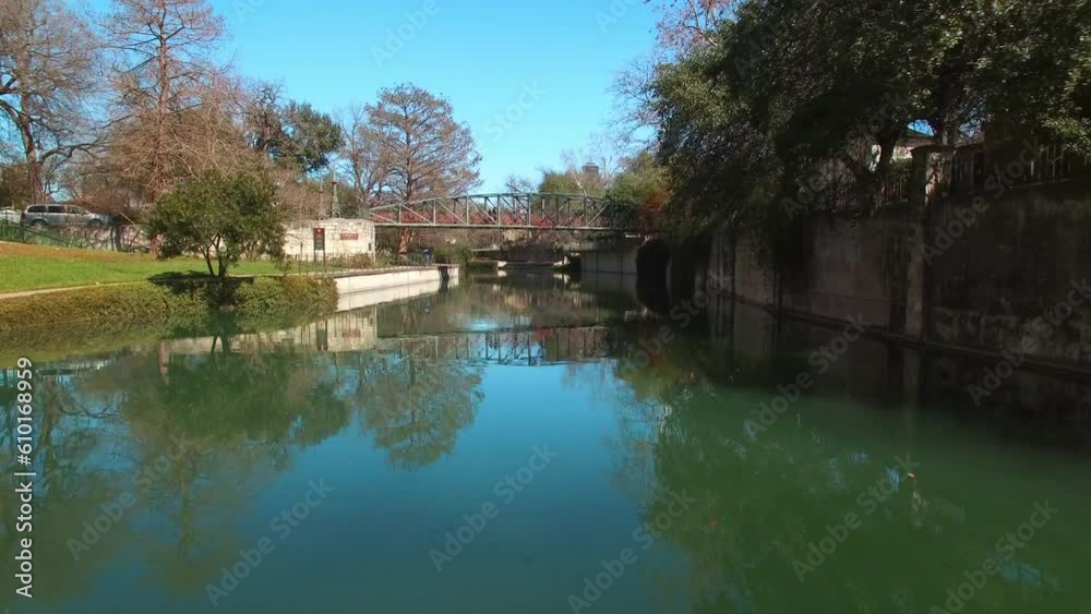 Aerial Panning Shot Of River Canal Amidst Trees By Buildings Against Sky, Drone Ascending Forward Suburb - San Antonio, Texas Aerial Panning Shot Of River Canal Amidst Trees By Buildings Against Sky, Drone Ascending Forward Suburb - San Antonio, Texas