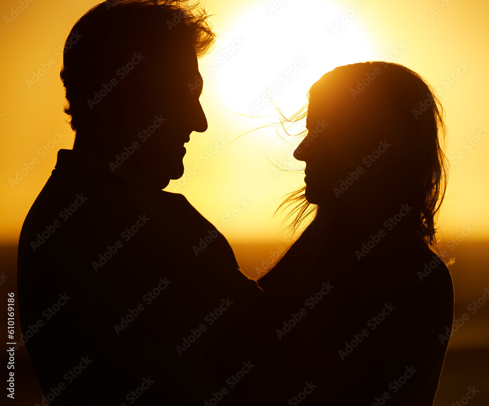 Silhouette, couple and love at sunset on beach for vacation, holiday or adventure outdoor in nature. Romantic man and woman in marriage with sky background for care, shadow art and travel freedom