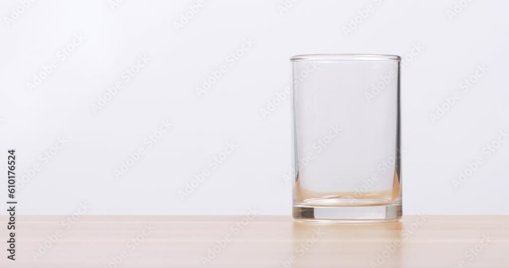 Pour fresh milk into a clear glass placed on the table, drink fresh milk for good health. Pour fresh milk into a clear glass placed on the table, drink fresh milk for good health.
