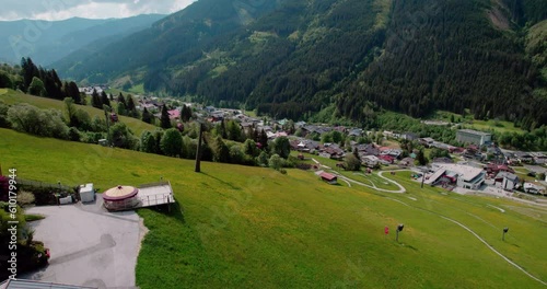 Kohlmaisbahn cable car with tourists in Saalbach Hinterglemm Austria lush valley photo