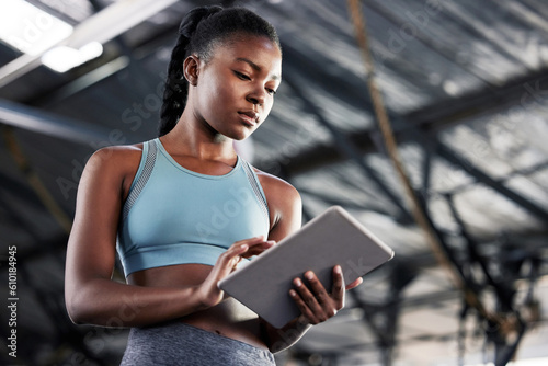 Black woman, planning or personal trainer with a tablet for fitness training, workout or sports exercise. Progress results, digital technology app or gym instructor typing an online coaching schedule