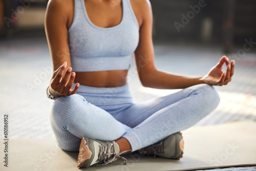Meditation, yoga and hands of woman in gym for wellness, mindfulness and breathing exercise on floor. Mental health, meditate and female person in lotus pose for calm, zen and balance in fitness