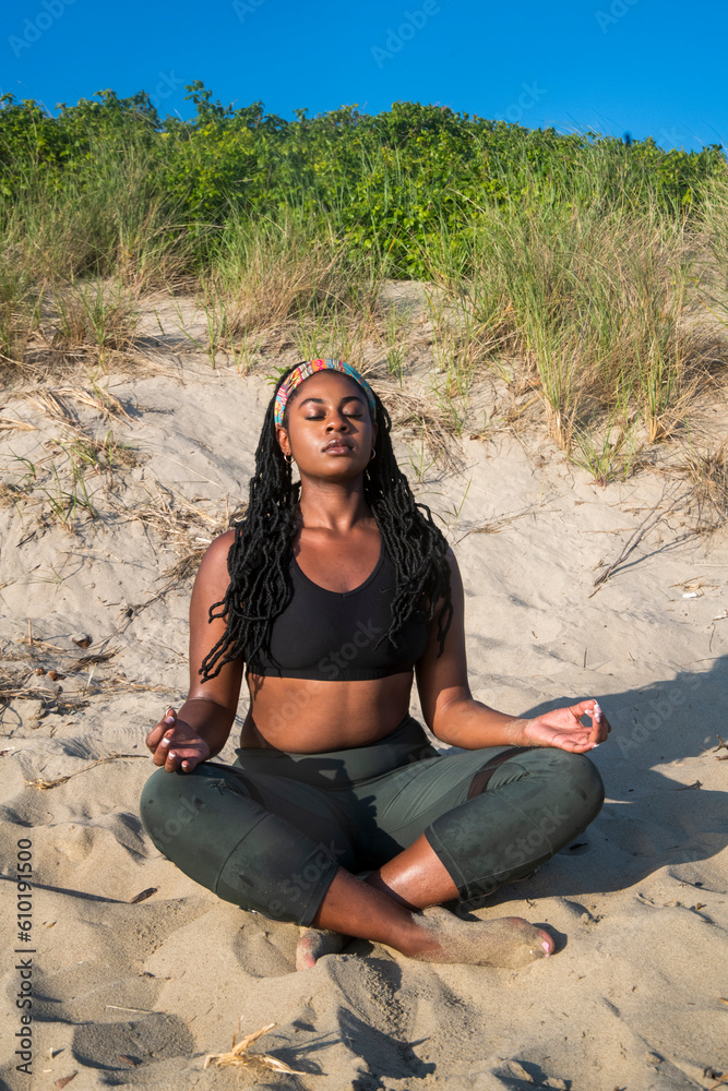 yoga at the beach with atlhletic afro american  woman