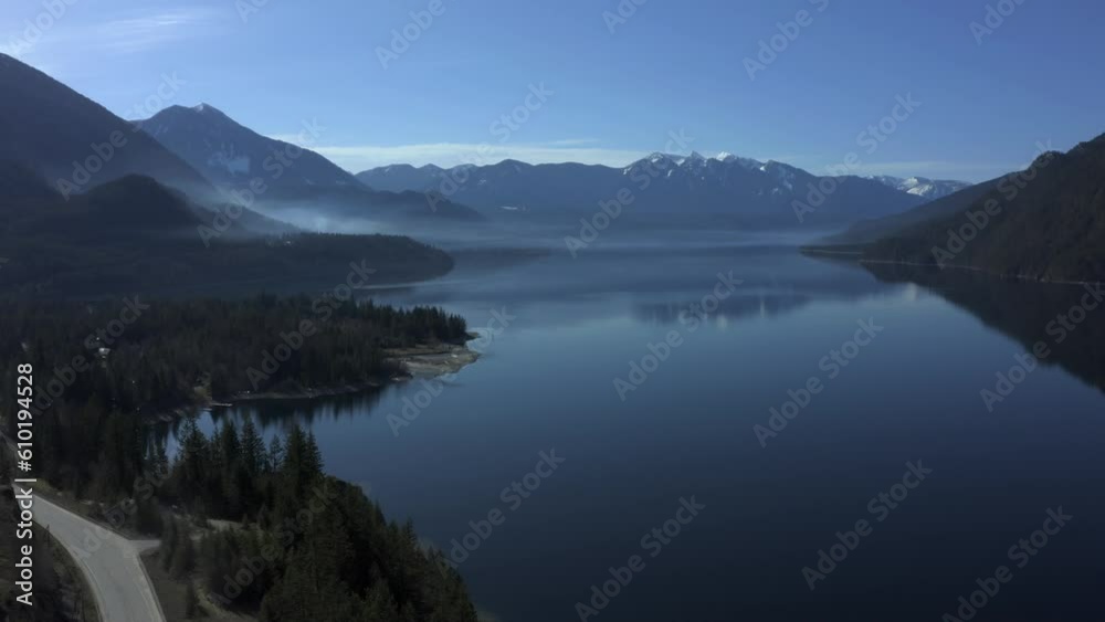 Serenity Unveiled: Smoke and Mirrored Reflections at Slocan Lake's Tranquil Shoreline Serenity Unveiled: Smoke and Mirrored Reflections at Slocan Lake's Tranquil Shoreline