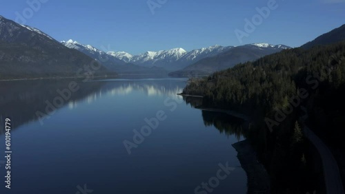 Mountain Majesty from Above: Gazing at Slocan Lake's Radiant Blue Gems amid Snow-Dusted Peaks photo