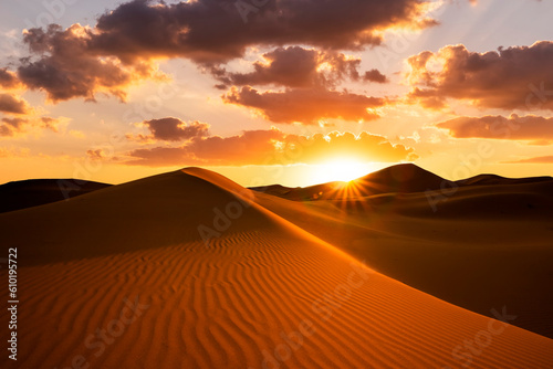 Sunset over the sand dunes in the desert. Arid landscape of the Sahara desert. © Anton Petrus