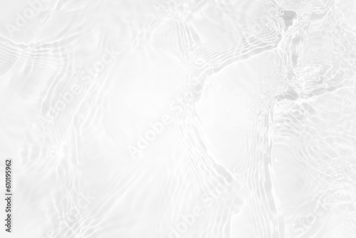 White water with ripples on the surface. Defocus blurred transparent white colored clear calm water surface texture with splashes and bubbles. Water waves with shining pattern texture background.