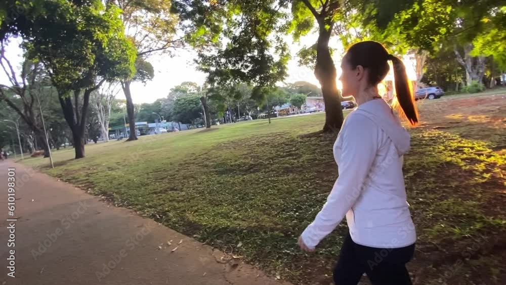 wide shoot of a middle age woman jogging on the park wide shoot of a middle age woman jogging on the park