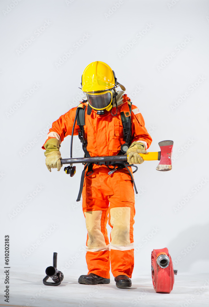 Professional firefighter wearing a yellow hard hat standing holding iron ax with both hands on white background. Professional firefighter wearing a yellow hard hat standing holding iron ax with both hands on white background.