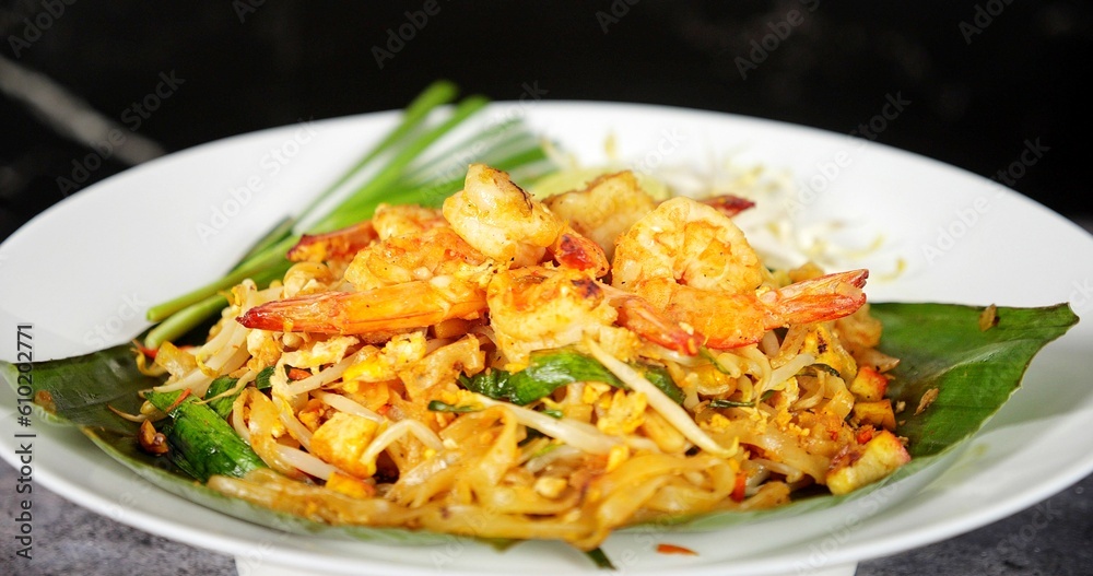 Thailand national dishes, Shrimps Pad Thai. Street food in Thailand. Thai fried noodles Pad Thai with shrimp and vegetables. Thai cuisine delicious Thailand national dishes, Shrimps Pad Thai. Street food in Thailand. Thai fried noodles Pad Thai with shrimp and vegetables. Thai cuisine delicious