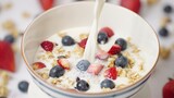 Milk pouring in bowl of healthy breakfast crunchy Granola Cereals with stawberry , blueberry vegan food, clean eating, dieting concept