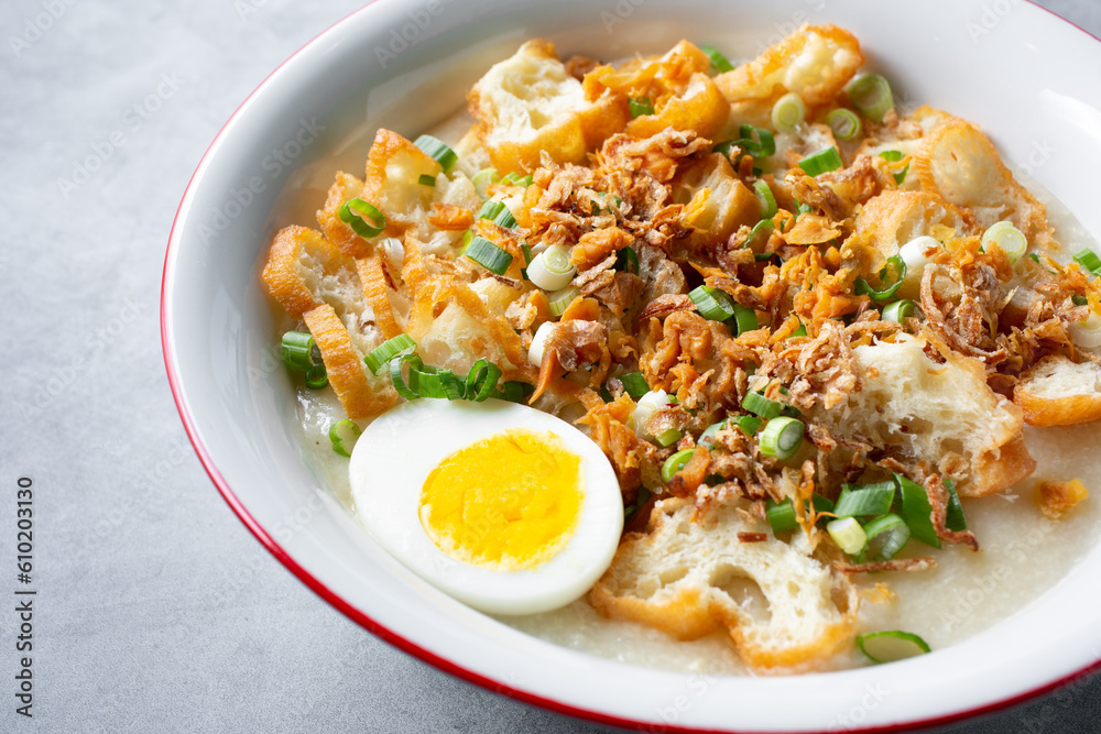 A closeup view of a bowl of bubur ayam. A closeup view of a bowl of bubur ayam.