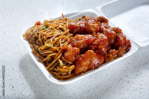 Принти на полотні A view of a 1 item combo of Chinese fast food, featuring orange chicken, chow mein and fried rice