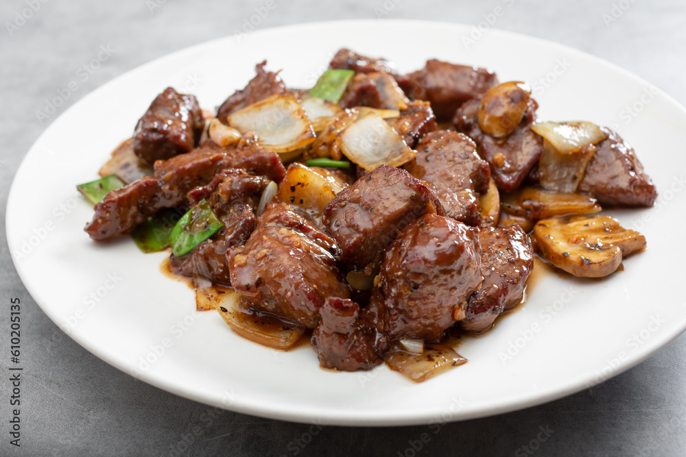 A view of a plate of black pepper beefsteak. A view of a plate of black pepper beefsteak.