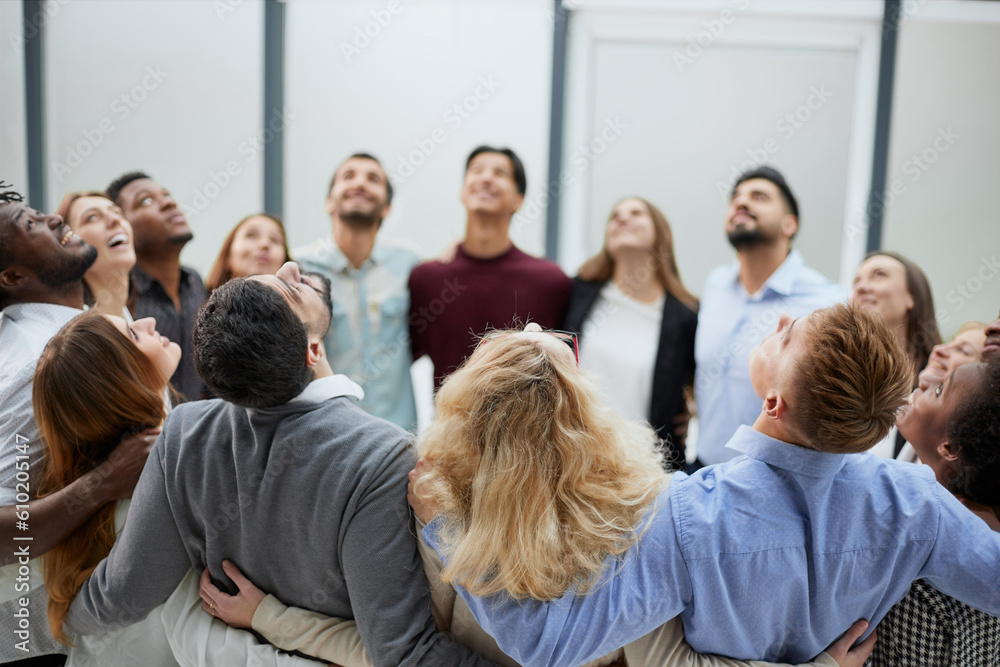 Obraz premium Team of young people hugging in the office.