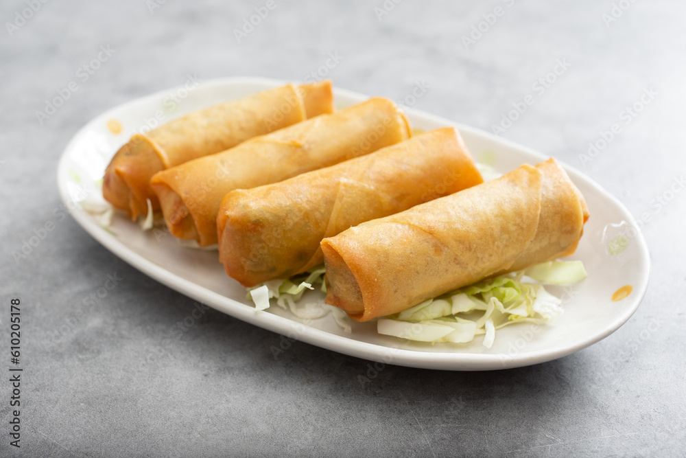 A view of a plate of egg rolls.
