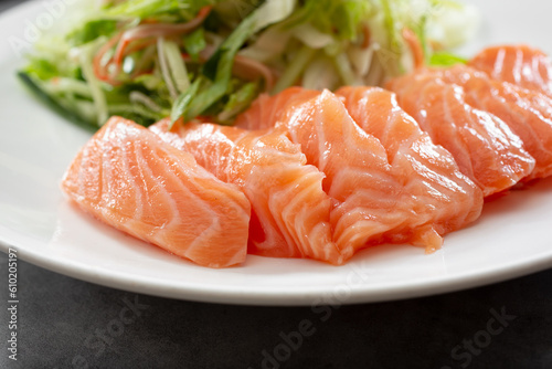 A closeup view of a plate of farmed Atlantic salmon sashimi.