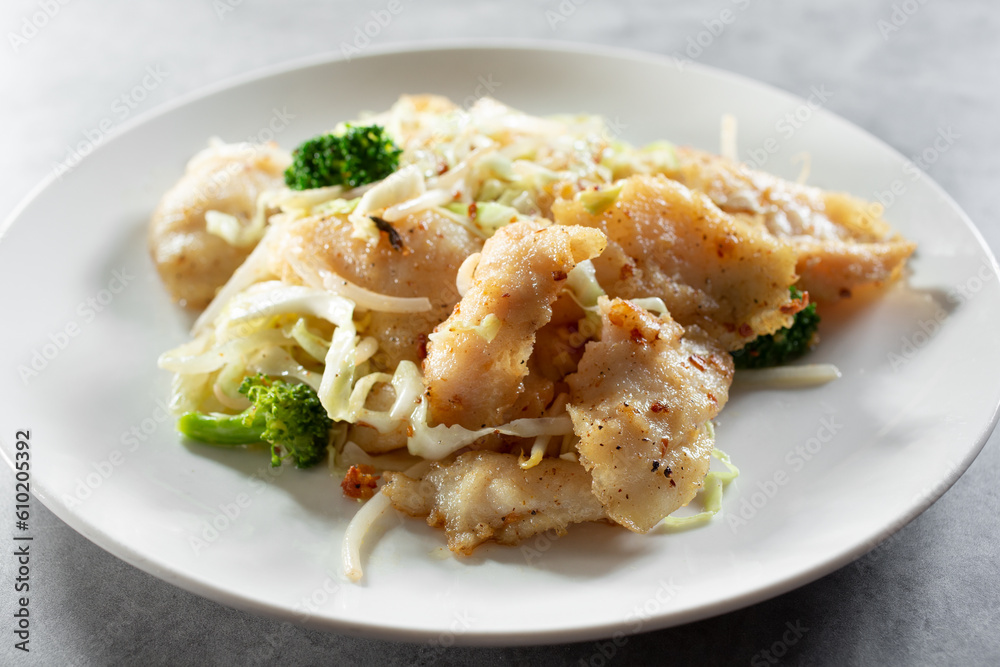 A view of a plate of lemon garlic fish.